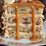 A slice of Banana Pecan Caramel Layer Cake with banana, pecans, and caramel topping.