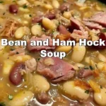 Bowl of hearty Bean and Ham Hock Soup with fresh herbs