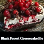 Slice of Black Forest Cheesecake Pie topped with cherries and whipped cream
