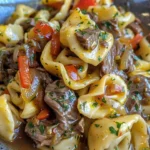 Cheesesteak tortellini in creamy provolone sauce served in a bowl
