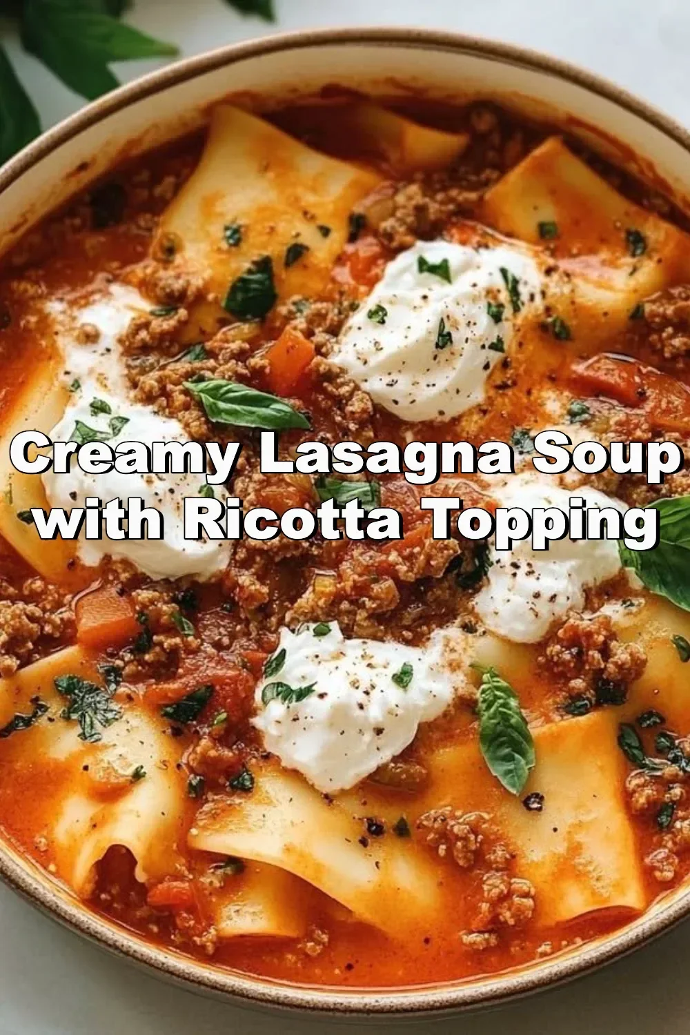 Creamy lasagna soup with a ricotta topping in a bowl