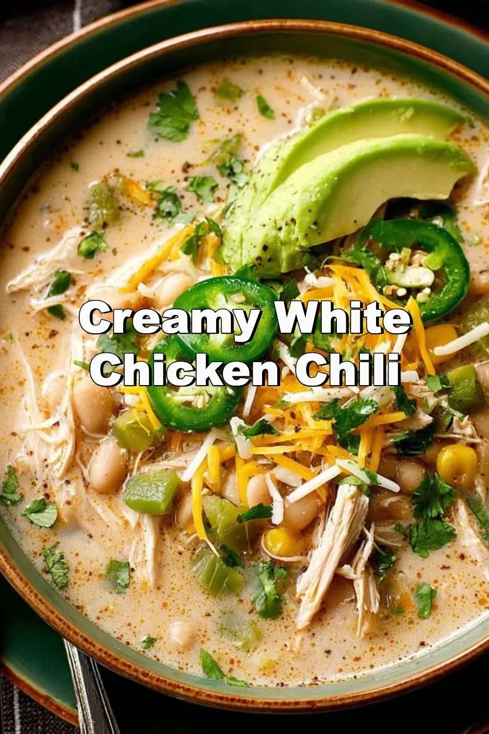 Bowl of creamy white chicken chili topped with herbs and cheese