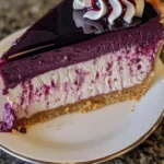 A slice of easy blueberry cheesecake topped with fresh blueberries on a plate.