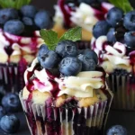 Elegant white chocolate blueberry cheesecake cupcakes on a dessert platter