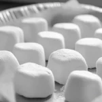 Fluffy homemade marshmallow bites on a white plate