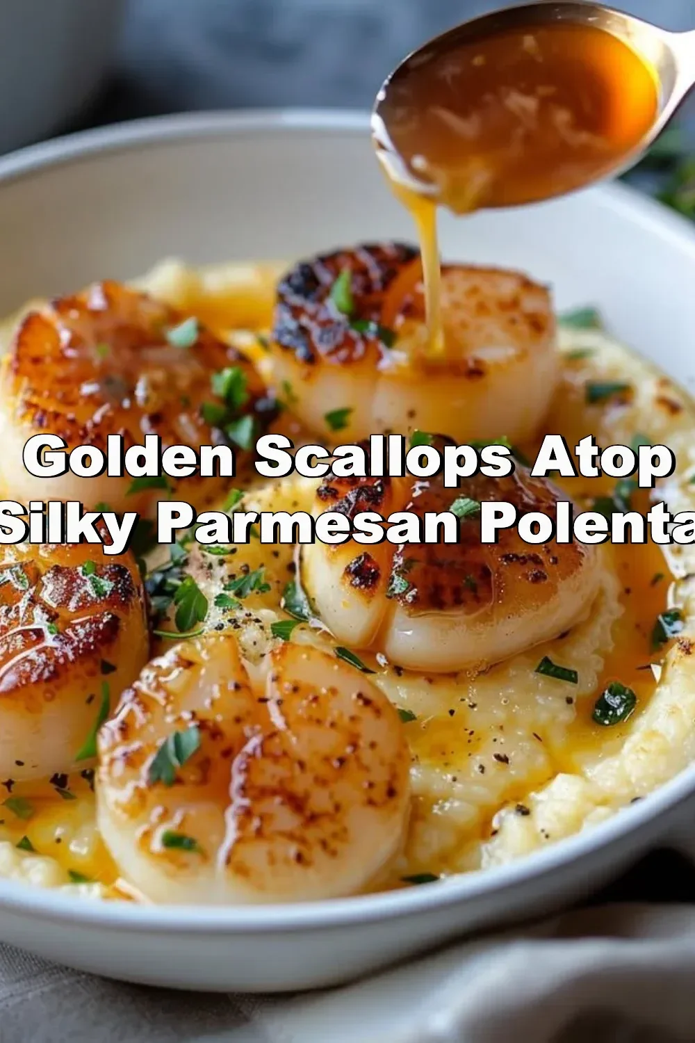 Golden scallops on silky Parmesan polenta garnished with herbs