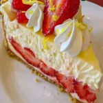 Irresistible lemon strawberry cheesecake topped with fresh strawberries.