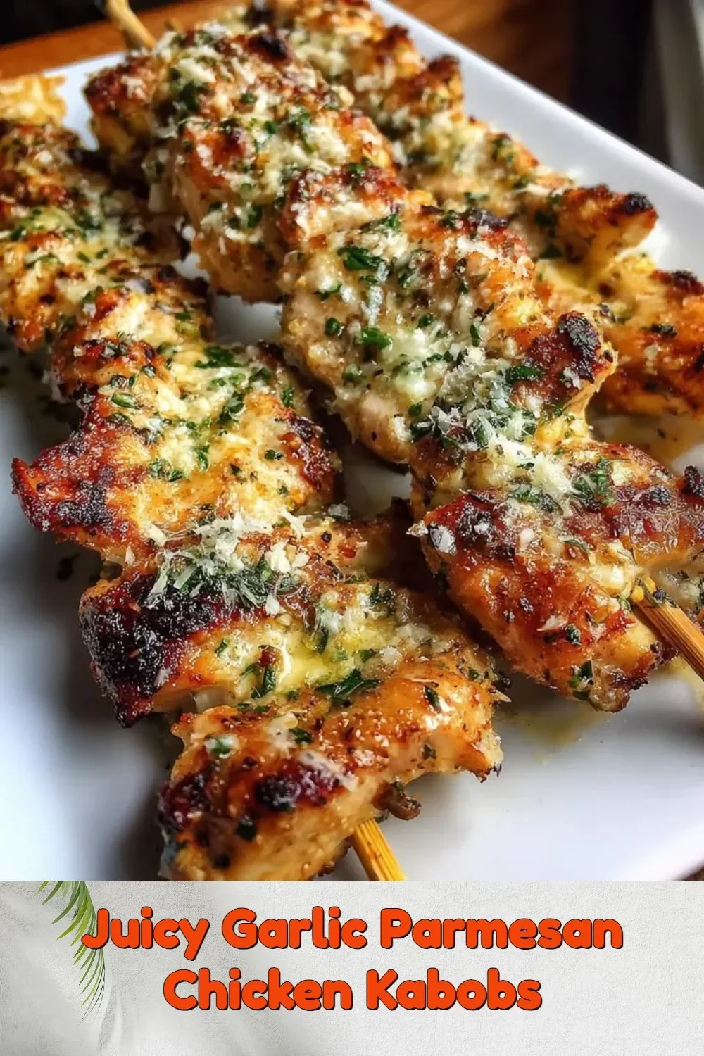 Juicy garlic parmesan chicken kabobs on the grill, garnished with herbs.