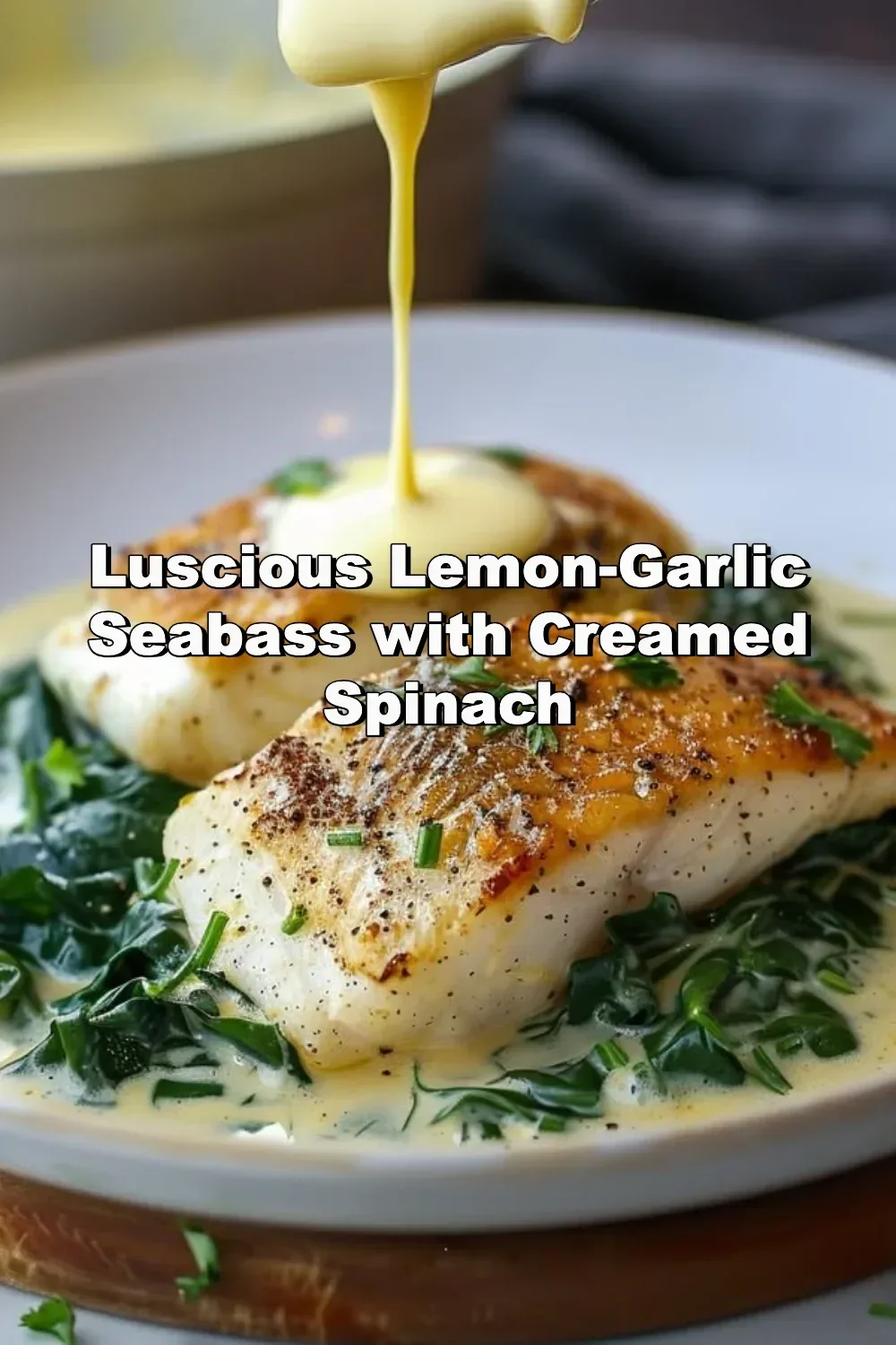 Lemon-garlic seabass served with creamed spinach on a dinner plate.
