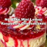 No bake mini lemon raspberry cheesecakes topped with fresh raspberries and lemon zest.