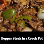 Delicious pepper steak simmering in a crock pot with colorful bell peppers and tender beef.