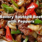 Plate of savory sautéed beef with colorful peppers served with rice.