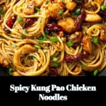 Delicious Spicy Kung Pao Chicken Noodles garnished with peanuts and vegetables.