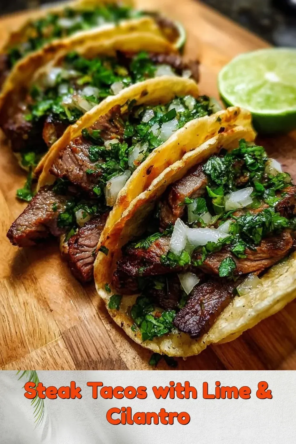 Delicious steak tacos topped with lime and cilantro on a wooden table