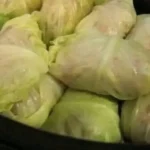 Plate of delicious stuffed cabbage rolls garnished with fresh herbs