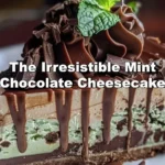 Slice of mint chocolate cheesecake topped with mint leaves and chocolate shavings