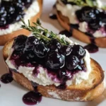 Whipped goat cheese crostini topped with blueberry balsamic glaze
