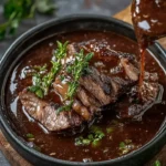Delicious homemade Beef Jus served over steak for a rich flavor boost.