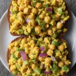 Delicious curried chickpea salad served in a bowl with fresh ingredients