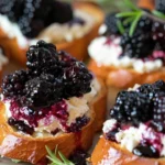 Delicious Blackberry Goat Cheese Crostini garnished with fresh blackberries.