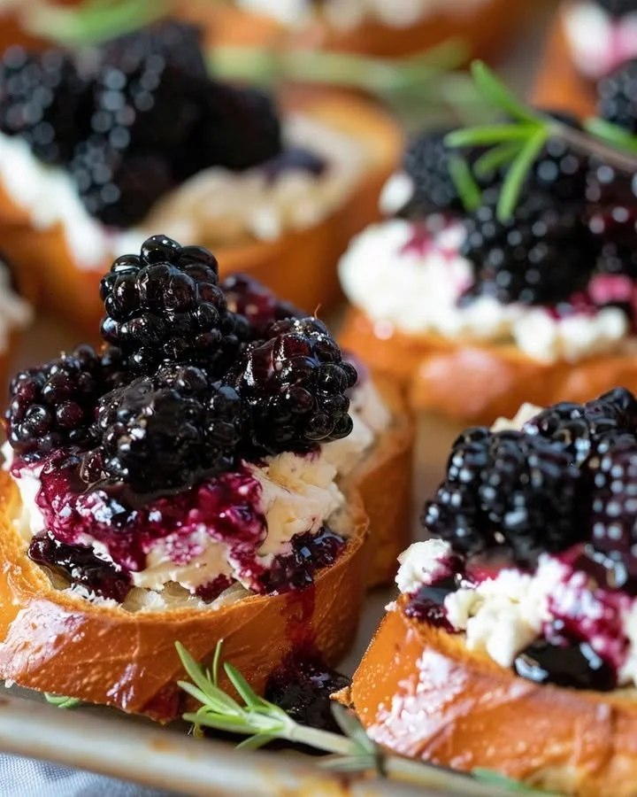 Delicious Blackberry Goat Cheese Crostini garnished with fresh blackberries.