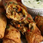 Cheesy chicken and veggie stuffed egg rolls served with avocado ranch dip.