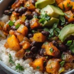 Chipotle roasted butternut squash and black bean bake served in a dish.