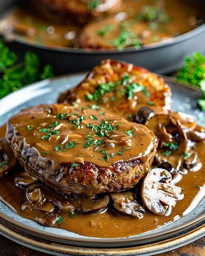 Classic Salisbury Steak served with rich mushroom gravy and garnishes