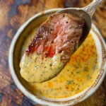 Delicious cowboy butter dipping sauce served in a bowl with fresh herbs