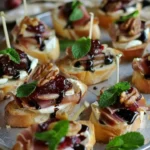 Cranberry Brie Crostini with prosciutto appetizers on a serving platter