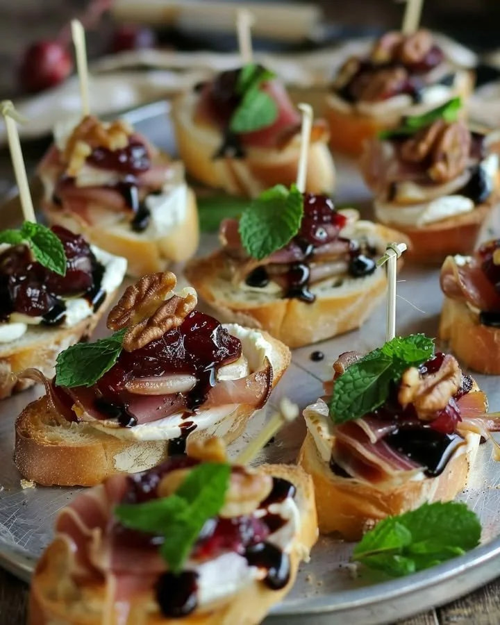 Cranberry Brie Crostini with prosciutto appetizers on a serving platter