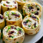 Creamy chicken cranberry pecan pinwheels served on a platter