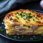 Creamy layered potato bake dish baked to perfection with cheese and herbs.