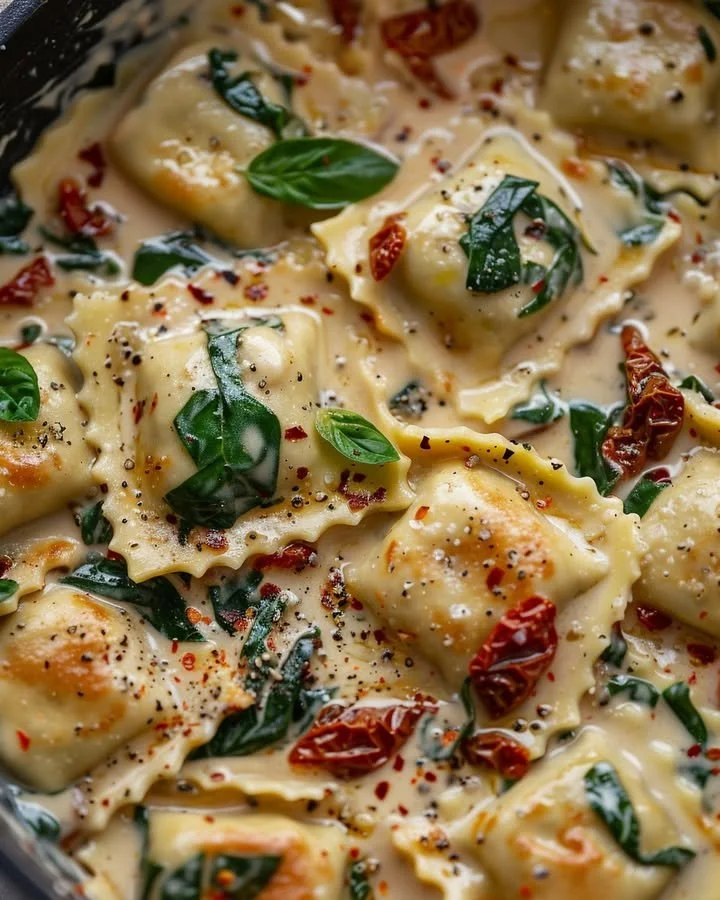 Creamy sun-dried tomato ravioli served with fresh herbs