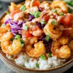 Crispy Bang Bang Shrimp Rice Bowl with zesty sauce and fresh toppings