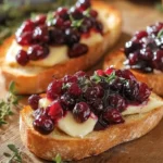 Crispy crostini topped with balsamic roasted cranberries and creamy brie