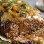 Delicious Crockpot French Onion Meatloaf garnished with onions and herbs