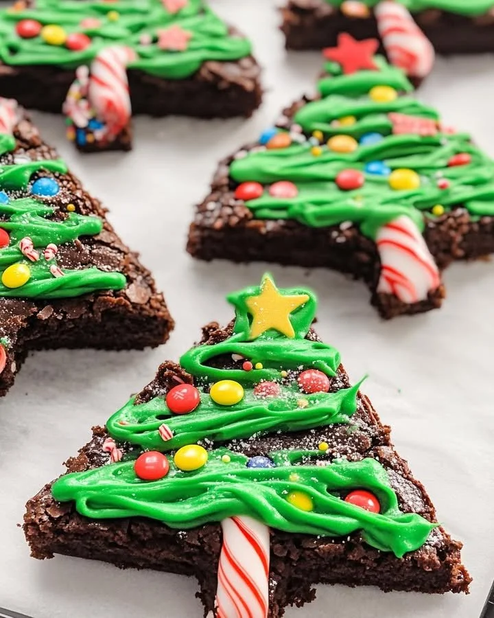 Festive Christmas Tree Brownies decorated with green icing and colorful sprinkles