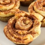 Golden Cinnamon Twist Muffins fresh out of the oven, topped with cinnamon sugar.