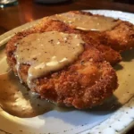 Golden country-fried steak topped with creamy homestyle gravy