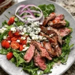 Delicious grilled steak salad with fresh vegetables and a tangy dressing.