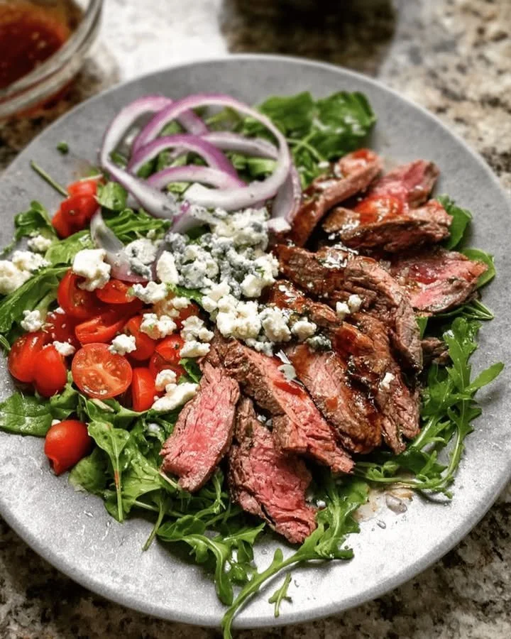 Delicious grilled steak salad with fresh vegetables and a tangy dressing.
