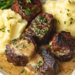 Juicy steak bites served with creamy Parmesan sauce and cheesy mashed potatoes.