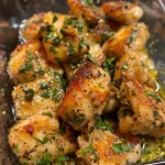 Plate of Lemon Garlic Butter Chicken garnished with herbs and served with vegetables.