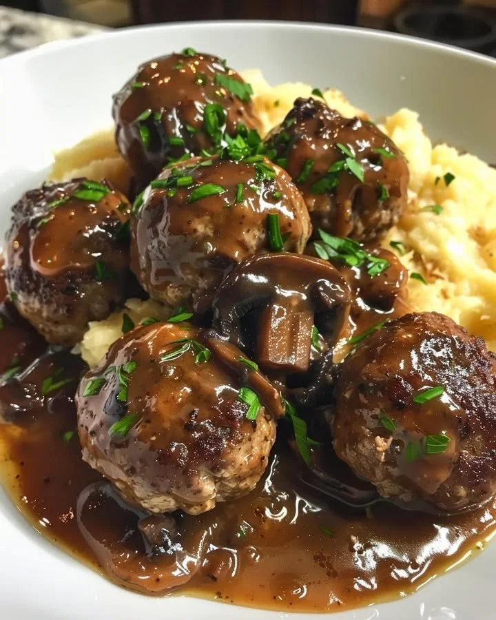 Meatballs served in a creamy mushroom sauce on a plate