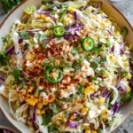 Delicious Mexican street corn coleslaw in a colorful bowl, garnished with cilantro.