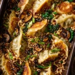 Bowl of oven-baked ramen served with golden dumplings on the side