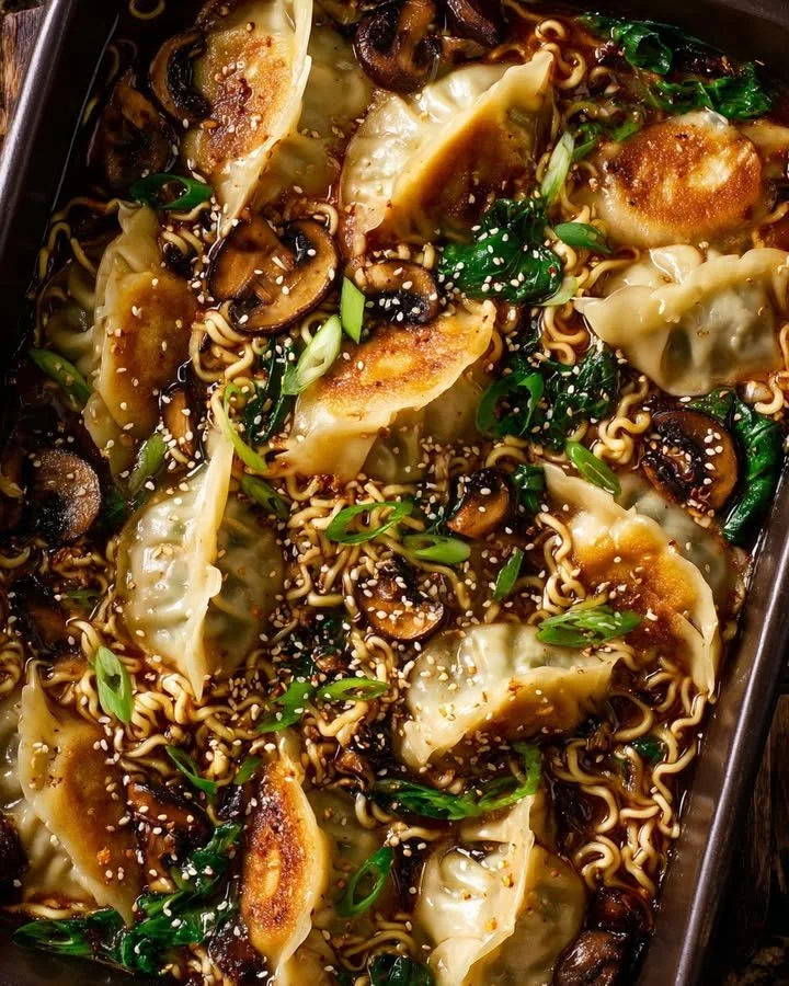 Bowl of oven-baked ramen served with golden dumplings on the side