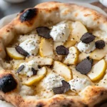 Gourmet Pear and Truffle Pizza topped with fresh ingredients and drizzled with truffle oil.