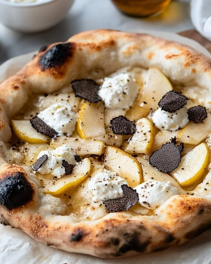 Gourmet Pear and Truffle Pizza topped with fresh ingredients and drizzled with truffle oil.
